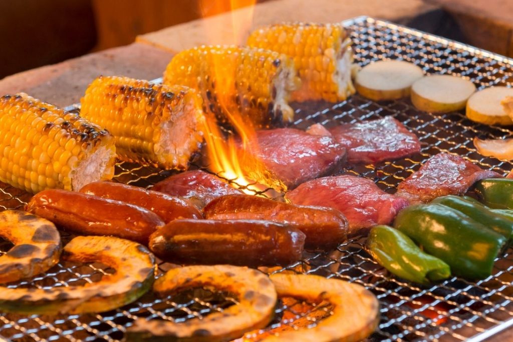 Wagyu beef and vegetables grilling over charcoal