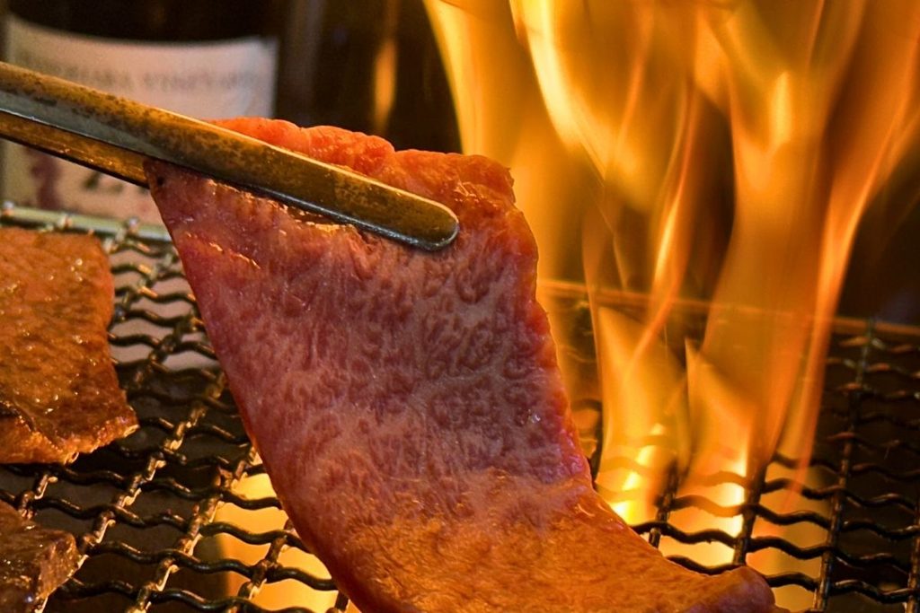 Wagyu beef being seared over the flame