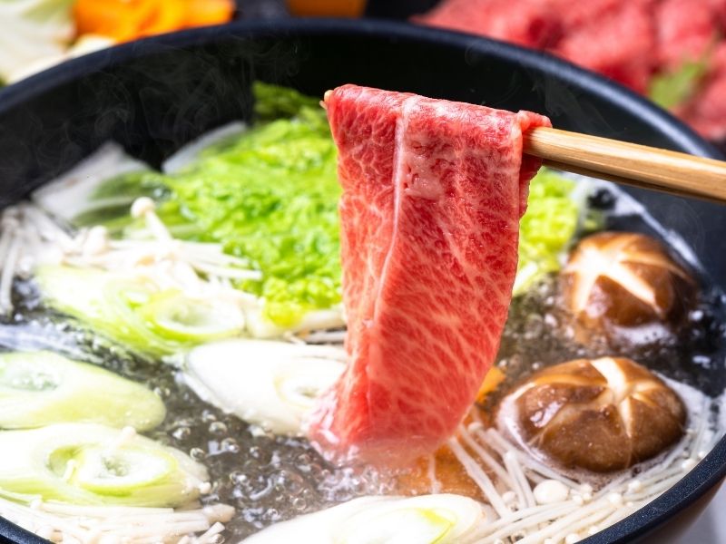 Dipping thinly sliced Wagyu beef into Shabu-Shabu broth