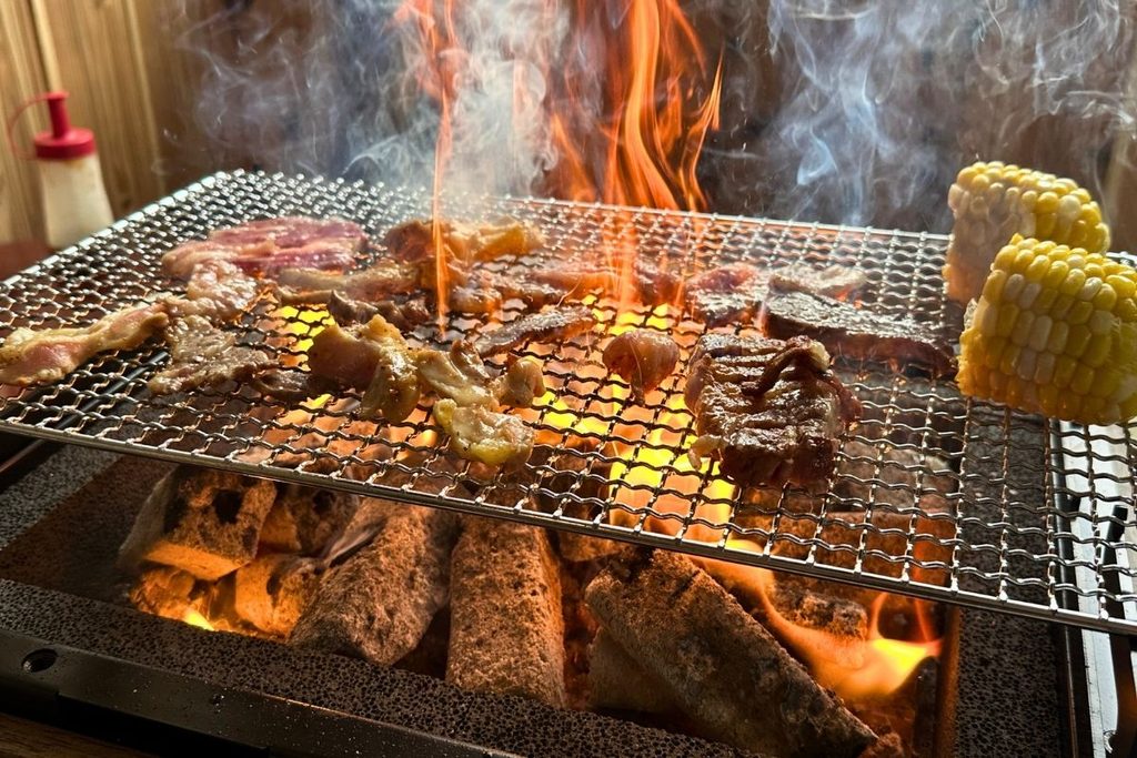 Wagyu BBQ cooking over charcoal flames